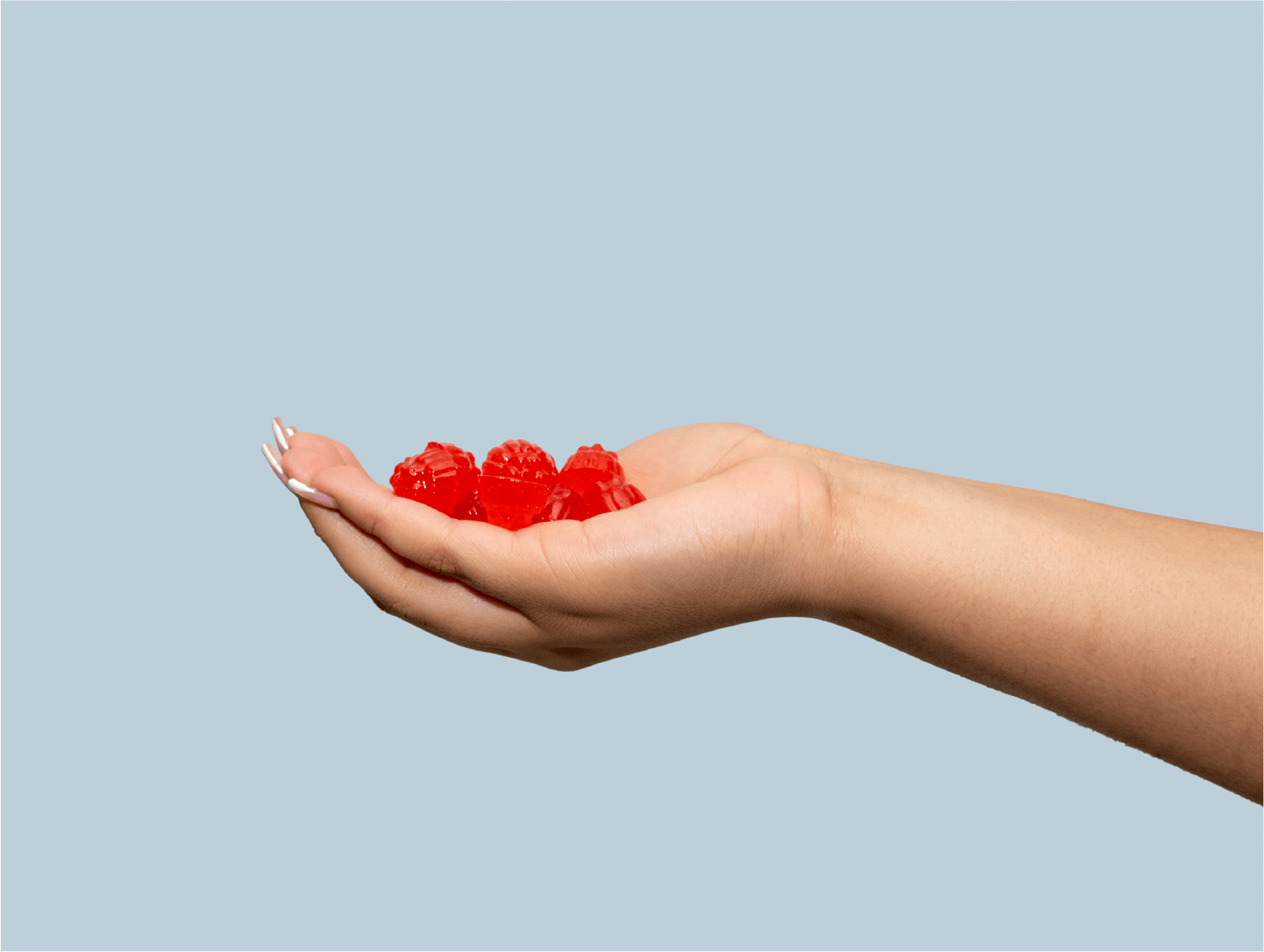 Orgum – Gomitas sin azúcar añadida con vinagre de manzana (60 unidades) en una mano, mostrando coloridas gomitas saludables.